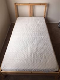 IKEA Twin Bed with Mattress: 1) Fjellse solid pine frame that you can make more personal by staining, painting or waxing. The bed frame is high enough so you can place storage boxes underneath. Retails for $39.99. Designed by Jon Karlsson. Article number: 201.805.66. Comes with original booklet. Length: 77 1/2", Width: 41", Footboard height: 13", Headboard height: 31 1/2". 2) Moshult mattress: resilient foam mattress, firm, white. Easy to keep clean with removable cover that can be machine washed. Retails for $99. Manufactured December 7th, 2014. Designed by Synnöve Mork. Article number: 202.723.49.