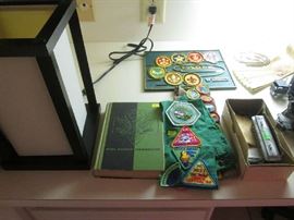Girl Scout, Brownie and Boy Scout badges and patches with a handbook