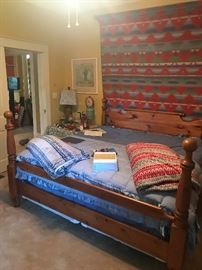 a large pine bed-king size. good mattresses and box springs- a Ralph Lauren blanket hangs over the bed