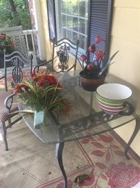 Outdoor table with four matching chairs and a heavy glass top