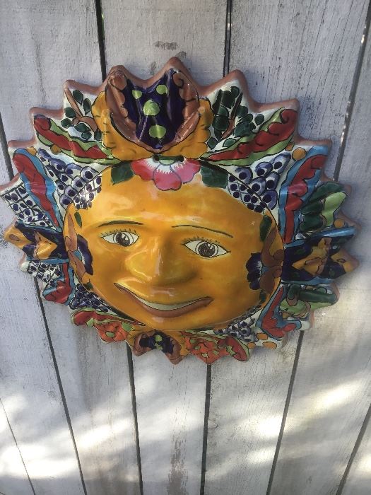 Beautiful pottery sunburst with a comical face