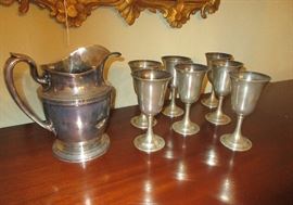 silver pitcher and goblets