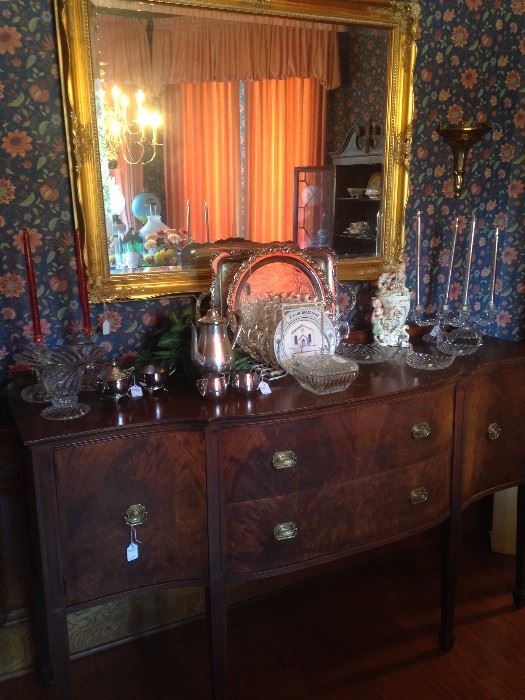 Impressive antique buffet with plenty of storage; large mirror; lovely glassware