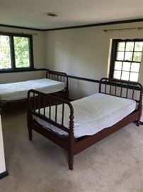 Two antique twin spindle / spool beds.