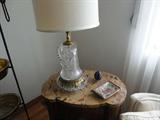 unusual cut glass lamp on top of a beautiful antique end-table