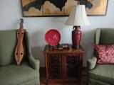 great looking pair of wingbacks on either side of an oriental carved chest