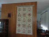 beautiful hand stitched heavy floor rug hanging on the wall in the living room