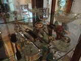 the large bow front cabinet in the dining room contains beautiful treasures