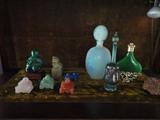 from the vitrine in the living room- hand carved buddahs, a collection of perfume bottles old and new