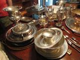 stacks of silverplate and sterling waiting to be placed for the sale