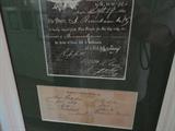 one of several old documents framed and hanging on the back hallway
