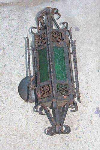 Antique wrought iron sconce with green glass