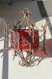 Antique wrought iron light fixture with red glass