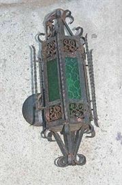 Antique wrought iron wall lamp with green glass