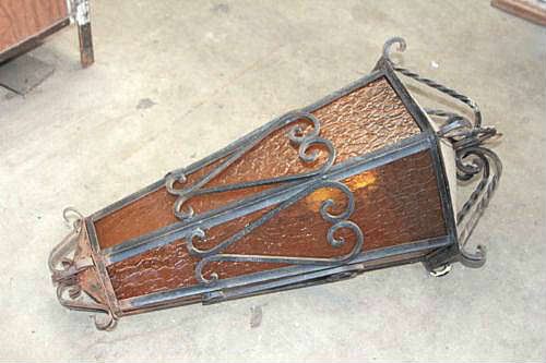 Antique wrought iron light fixture with amber glass