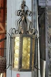 Antique wrought iron  light fixture with yellow glass