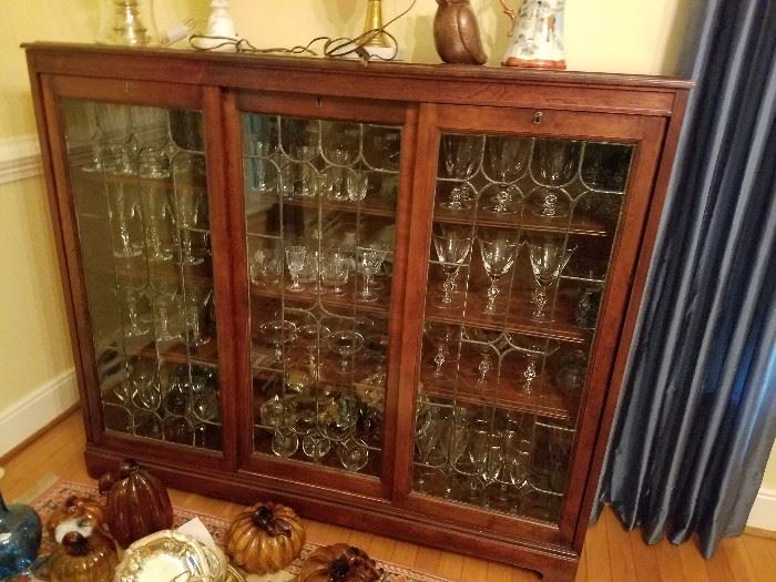 antique cabinet with glassware and crystal