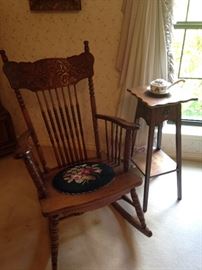 Antique rocker with needlepoint seat; small antique side table