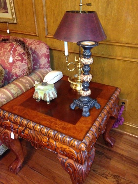The end table matches the coffee table with its intricate carving.