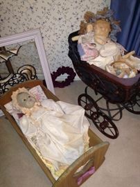 Antique dolls, cradle, and carriage