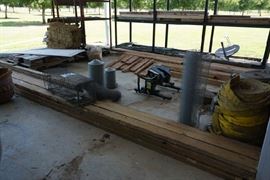 Chicken feeders, wire, fire hoses. stack of tile, metal storage rack