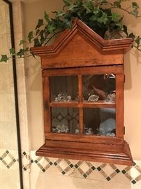 Display shelf with collection of crystal pieces