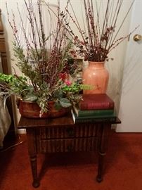 two drawer night stand, floral arrangements, old books