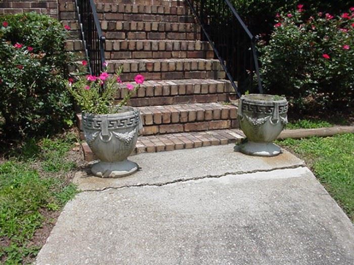Pair of concrete planters with Greek key design and garlands
