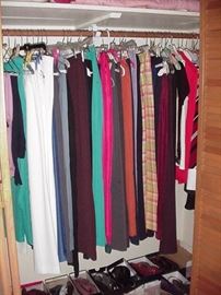 Lots of women's clothes--slacks and skirts in this closet; sizes small and medium; also size 7 shoes