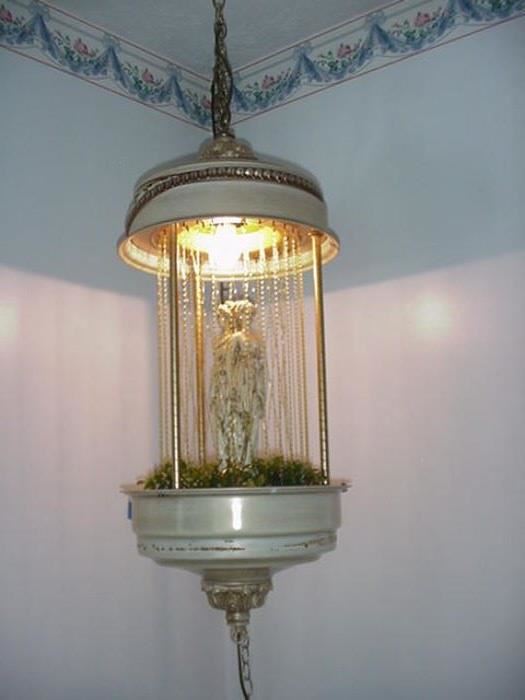 Hanging oil lamp with figurine in center