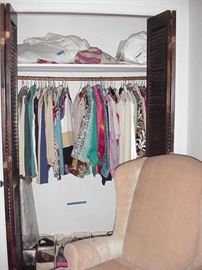 Closer view of clothing with shoes--size 7s-- below and bed linens above