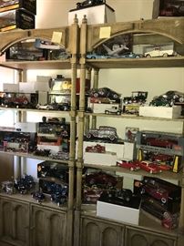 Probably a hundred scale model cars, in 1/24, 1/18, etc scale cars in metal or plastic, by Franklin Mint, Maisto and many more makers.