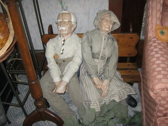 Elderly couple large dolls seated on a bench