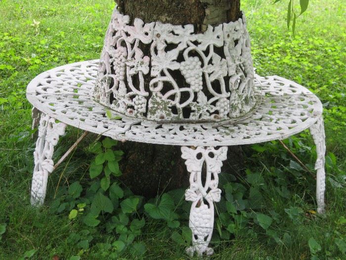 Cast iron bench surrounds a tree - 2 of these