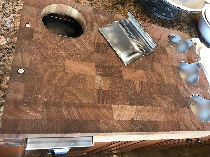 Very interesting kitchen cutting board. place your cuttings in the pull out stainless drawer and measuring cups included!