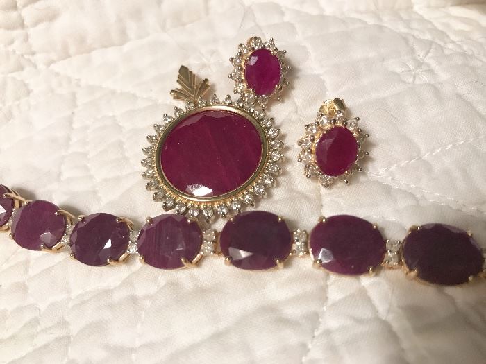 A nice selection of fine and costume jewelry.  Here Rough cut ruby pendant with diamonds  set.  