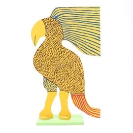 Marvin Finn Folk Art Parrot Sculpture: A hand-crafted wood parrot sculpture by folk artist Marvin Finn (1913 – 2007). This piece is made of a carved, flat board mounted on a wood base. It depicts a bird with a parrot-like beak, blue striped plume, red-striped tail, and blue and brown speckles, all over yellow. The base is painted light green. The piece is signed “Finn 88” on the underside.