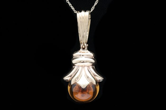 14K Gold and Citrine Pendant with Chain: A 14K gold and citrine pendant with chain. The pendant features a round citrine suspended from a 14K yellow gold setting and bail with a pearl enhancer.