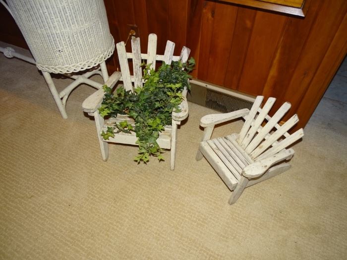 Two child-size adirondack chairs.