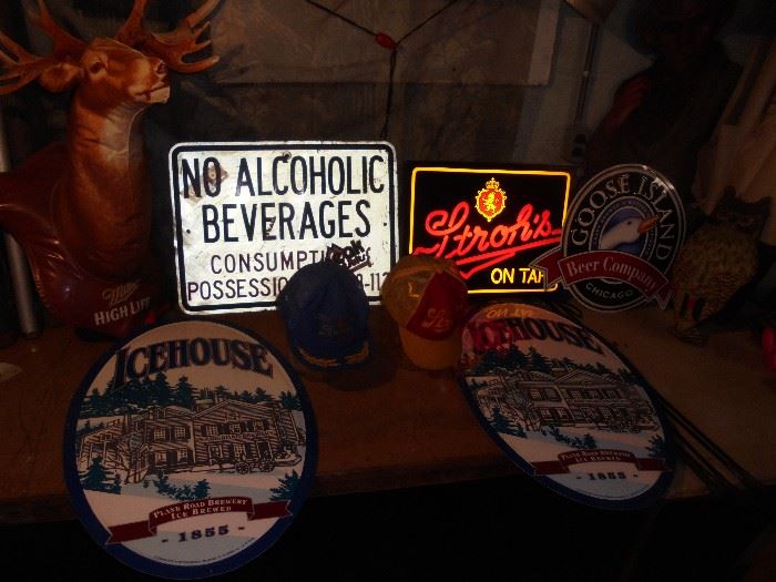 Beer signs and a couple of Stroh's hats