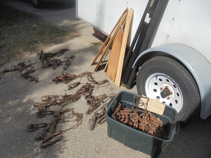 Tote full of complete #110 Body Traps and a collection of #1 Long Spring Traps. Also stacked against trailer are a collection of unused wooden skin stretchers. Also available, but not pictured is a collection of spring wire stretchers.