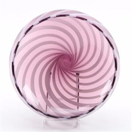 Waterford Glass Bowl "Evolution": A Waterford glass bowl Evolution. The bowl is hand blown molten crystal from the Urban Safari collection and features a 5" size with a purple tinted glass and white inset swirls that taper to a circular uncolored glass base. The bowl is labeled to the base with an etched and frosted “Waterford”.