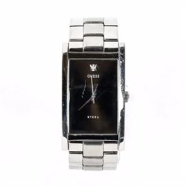 Guess Watch: A Guess watch. The watch is stainless steel and water resistant to 50 meters. It is style G95374G. The watch has a diamond accent at the 12 o’clock marker. It also has Japan movement.