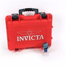 Invicta Watch with Case: An Invicta watch with case. The watch is an Invicta Pro Diver Masters of the Oceans tritnite type. It is stainless steel, 100 m water resistant and is style 17793. The crystal is flame fused. The band is blue rubber. It comes with a case that holds multiple watches.