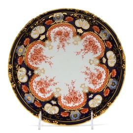 Vintage Royal Crown Derby Bone China Plate: A 1922 Royal Crown Derby bone china plate. This decorative plate has cobalt blue border with a gilt floral overlay, and an iron red and powder blue floral motif. It is marked to the bottom “Royal Crown Derby Made in England” with crown mark and retailer “Bailey Banks & Biddle Co. Philadelphia”.