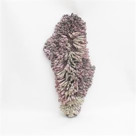 Signed Mixed Media Paper Wall Sculpture: A signed mixed media paper sculpture. This wall hanging sculpture features an amorphous coral-like shape formed from dozens of purple and gray rolled columns of art paper. The work is hand signed on the verso “E. Barron ‘Boomwah’” and dated 1984.