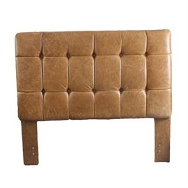 King Size Tufted Leather Headboard: A king size tufted leather headboard. This rectangular headboard features a button tufted grid pattern. The headboard is upholstered in a brown tone leather and rises up on panel stiles.
