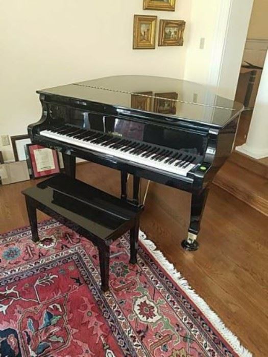 Black lacquer Wurlitzer baby grand piano and stool