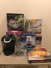 Keurig coffee, ice cream maker, large crystal platter, pedestal cake stand with dome, Braun 10 cup coffee maker, stone pizza set, etc 