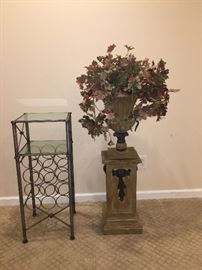 Pier1 12 bottle wine rack with 2 glass shelves and pedestal stand with urn and Floral greenery. 